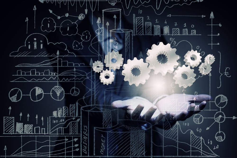 Close up of businesswoman holding gears in hand