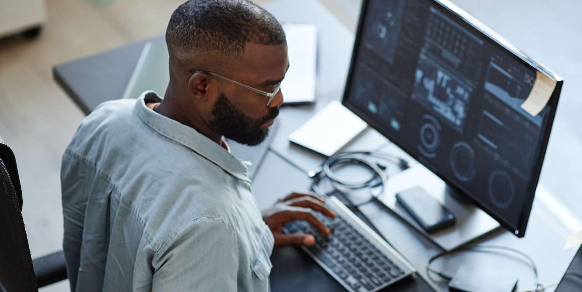 man using monitoring tools to analyze system performance, health, and potential issues